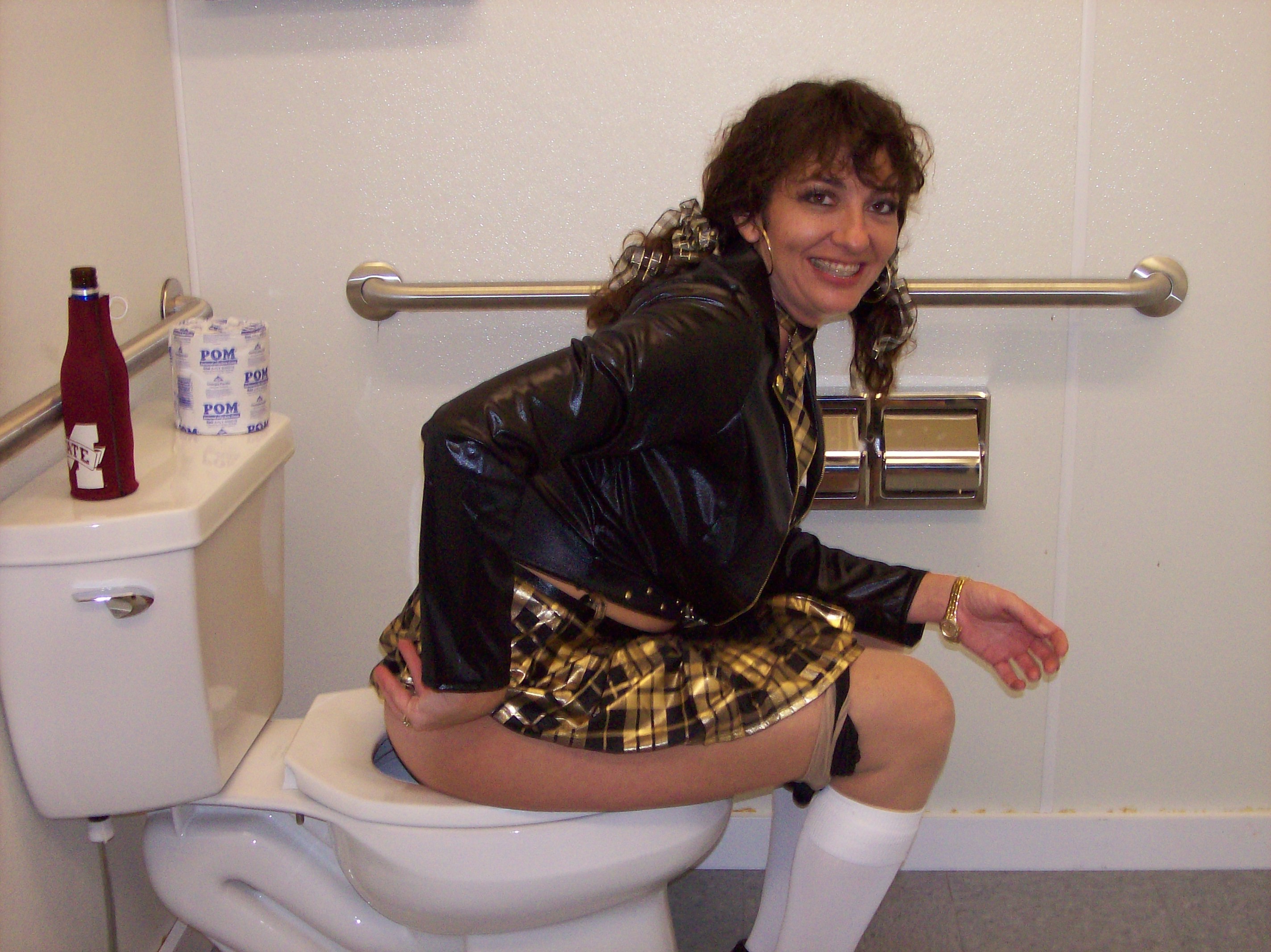 Sitting on toilet peeing